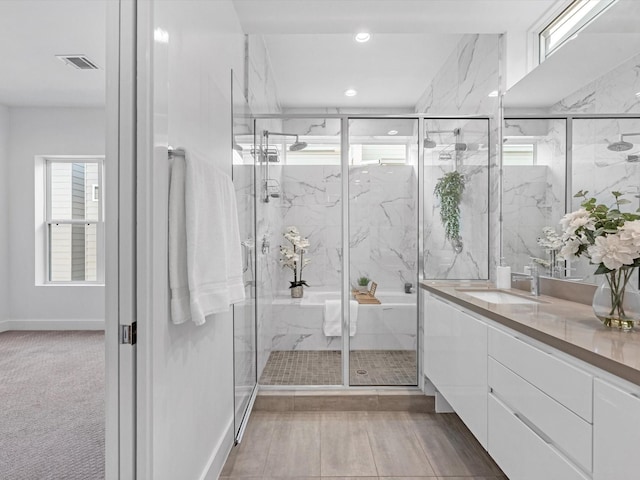 bathroom with walk in shower and vanity