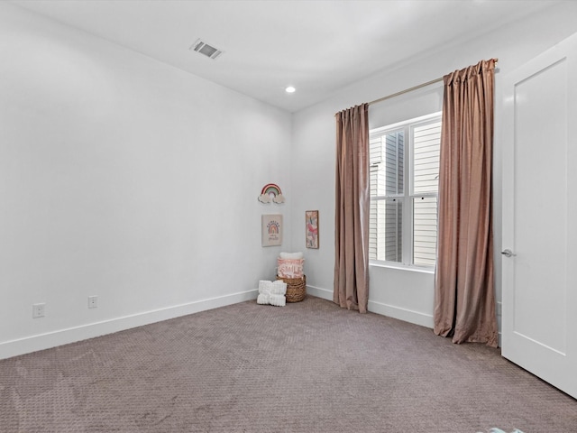 unfurnished room featuring light colored carpet