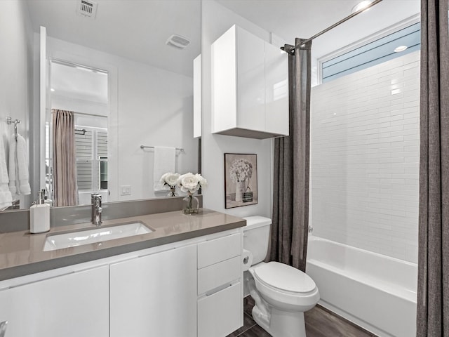 full bathroom featuring shower / tub combo with curtain, vanity, and toilet