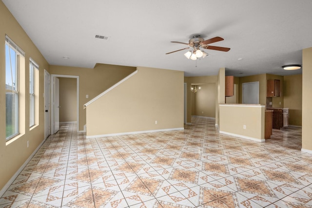 unfurnished living room with ceiling fan