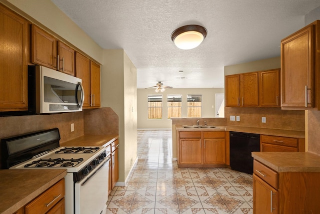 kitchen with tasteful backsplash, black dishwasher, white gas range oven, ceiling fan, and kitchen peninsula