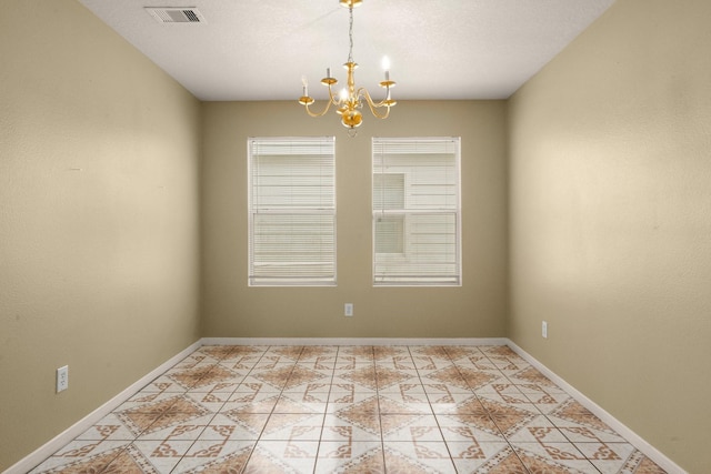 unfurnished room featuring an inviting chandelier and light tile patterned floors