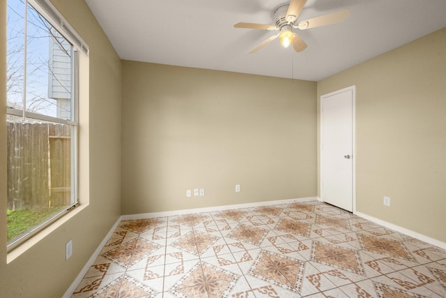 spare room featuring light tile patterned floors and ceiling fan