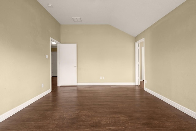 empty room featuring dark hardwood / wood-style floors and vaulted ceiling