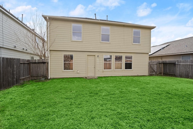 rear view of house with a lawn