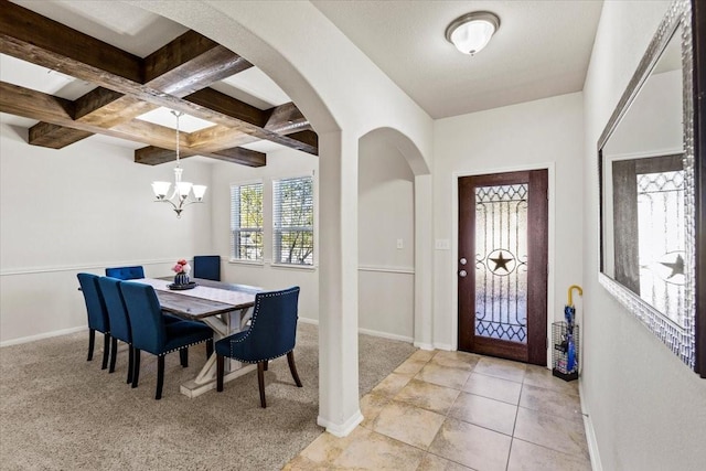 carpeted dining area featuring coffered ceiling, an inviting chandelier, and beam ceiling