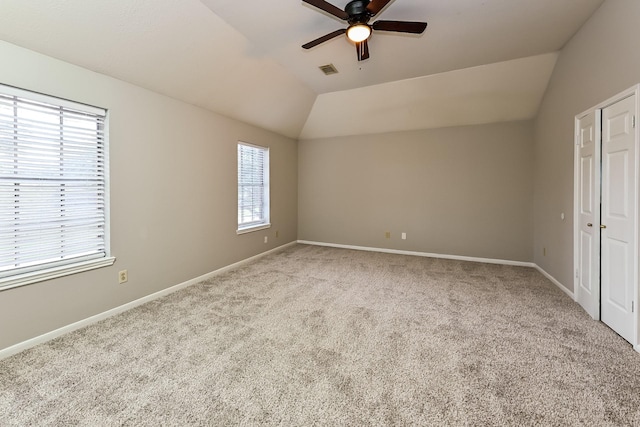 unfurnished bedroom with lofted ceiling, light carpet, and ceiling fan