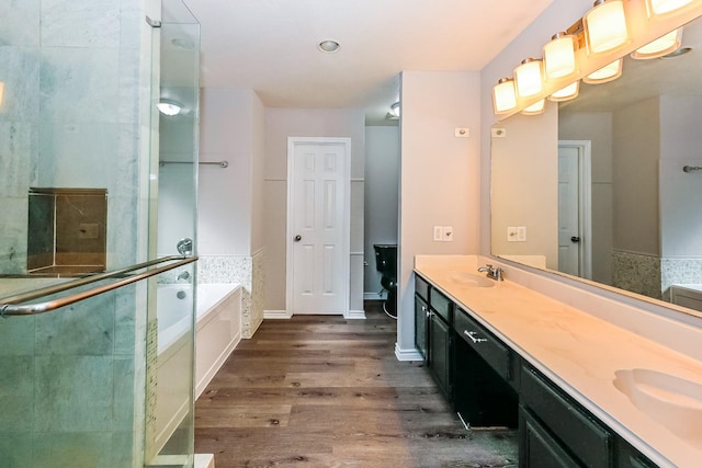 bathroom featuring independent shower and bath, vanity, and hardwood / wood-style floors