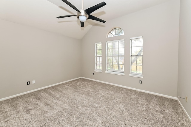 carpeted spare room featuring vaulted ceiling and ceiling fan