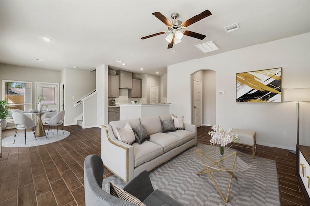 living room with dark wood-type flooring and ceiling fan