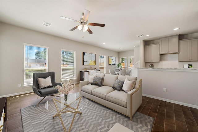 living room featuring dark hardwood / wood-style floors and ceiling fan