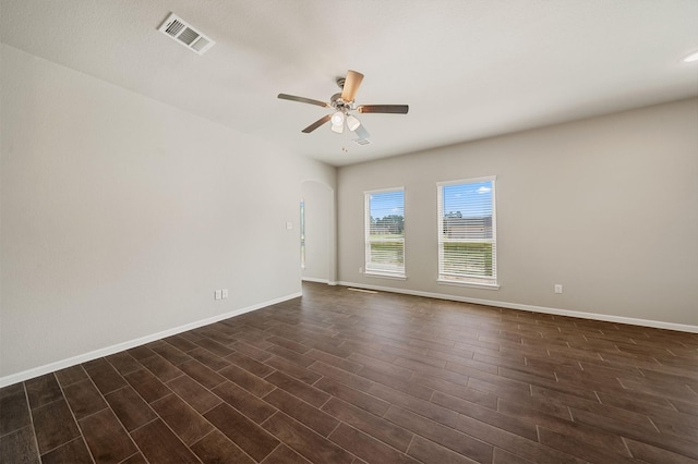 empty room with dark wood-type flooring and ceiling fan