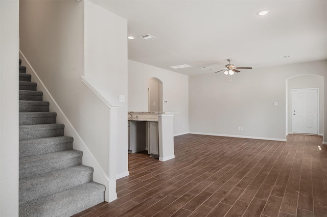 unfurnished living room with ceiling fan and dark hardwood / wood-style floors