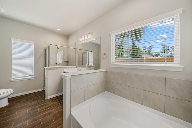 full bathroom featuring vanity, shower with separate bathtub, hardwood / wood-style floors, and toilet