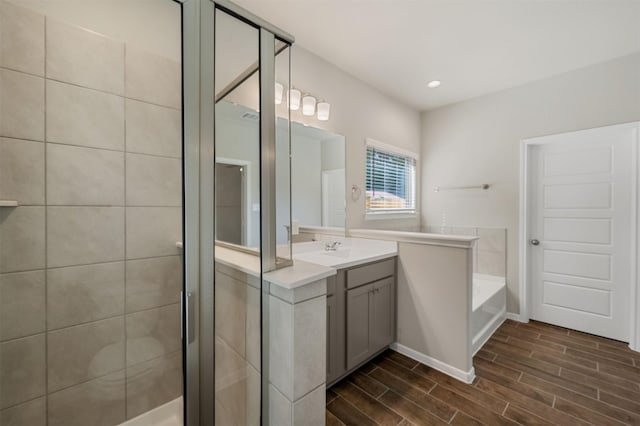 bathroom featuring vanity and shower with separate bathtub