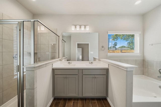 bathroom featuring shower with separate bathtub and vanity