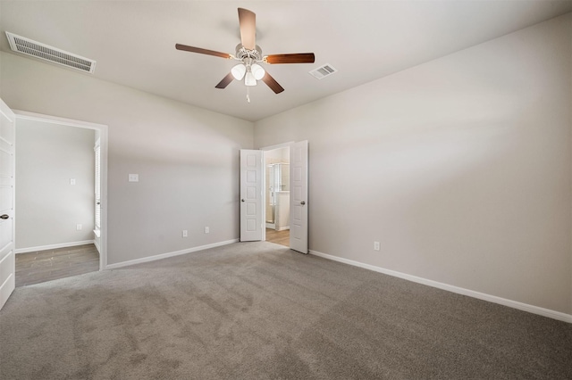 unfurnished bedroom with light carpet, ceiling fan, and ensuite bathroom