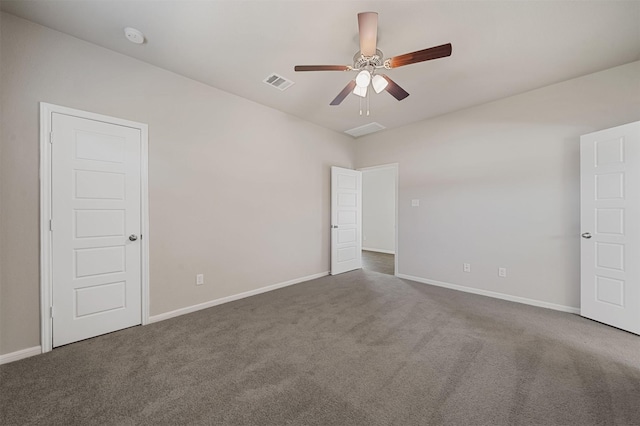 carpeted spare room featuring ceiling fan