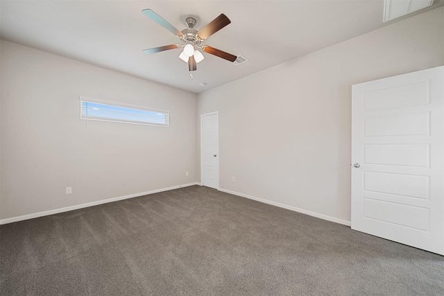 spare room with ceiling fan and dark carpet