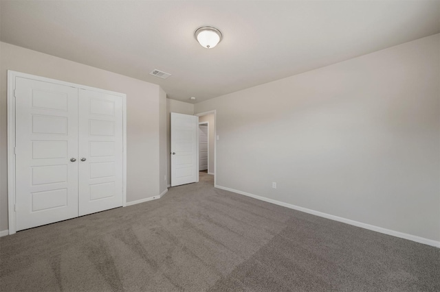 unfurnished bedroom with a closet and carpet