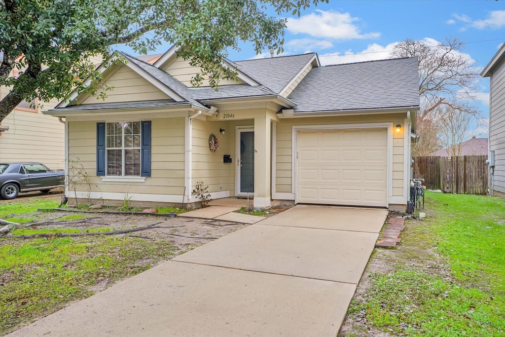 view of front of property with a garage and a front lawn