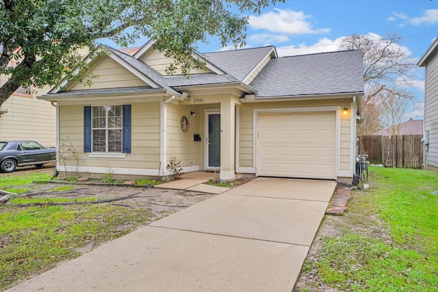 view of front of property with a garage and a front lawn