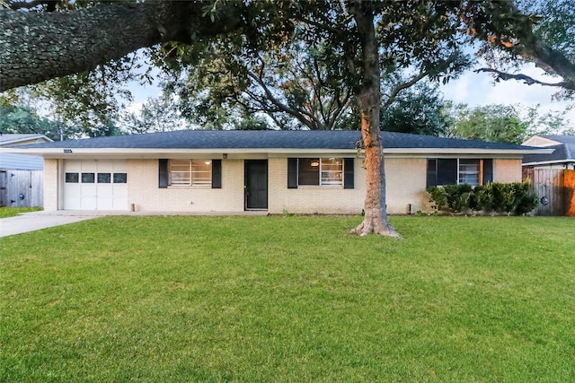 ranch-style house with a garage and a front lawn