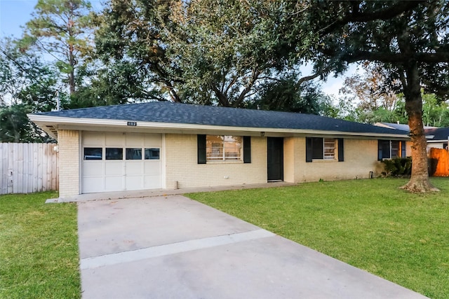 ranch-style home featuring a garage and a front lawn