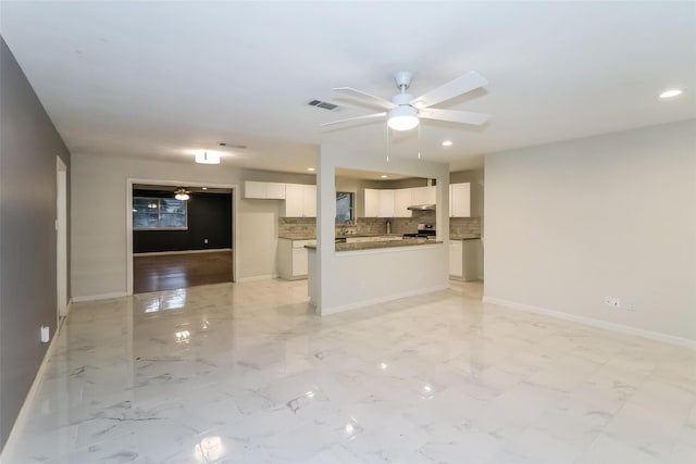 unfurnished living room featuring ceiling fan