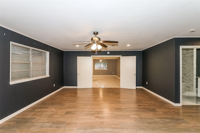 empty room with crown molding, ceiling fan, and hardwood / wood-style floors