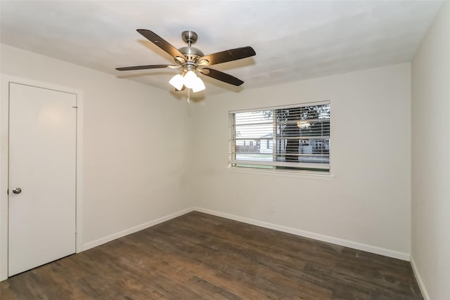 empty room with dark wood-type flooring and ceiling fan