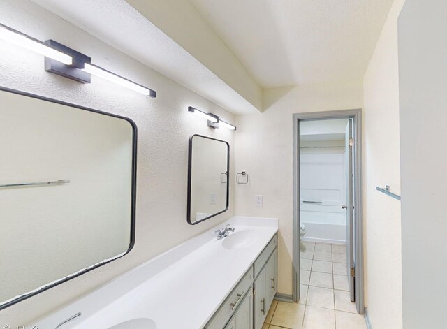 bathroom featuring vanity, tile patterned floors, and toilet