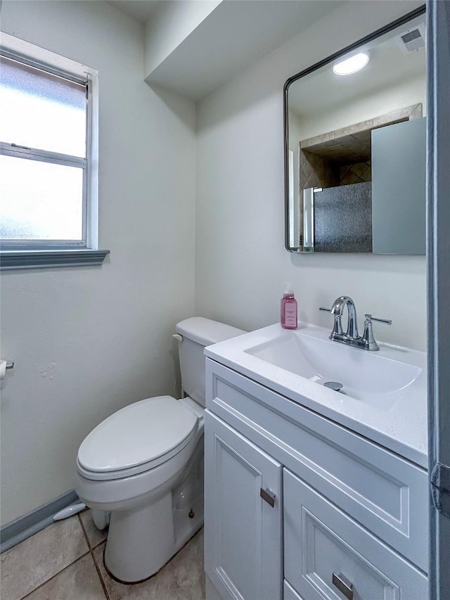 bathroom with vanity, tile patterned flooring, and toilet