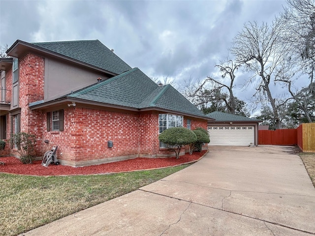 view of side of home featuring a yard and a garage