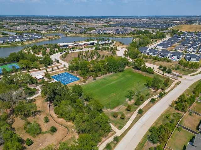 aerial view of property's location featuring nearby suburban area and a large body of water