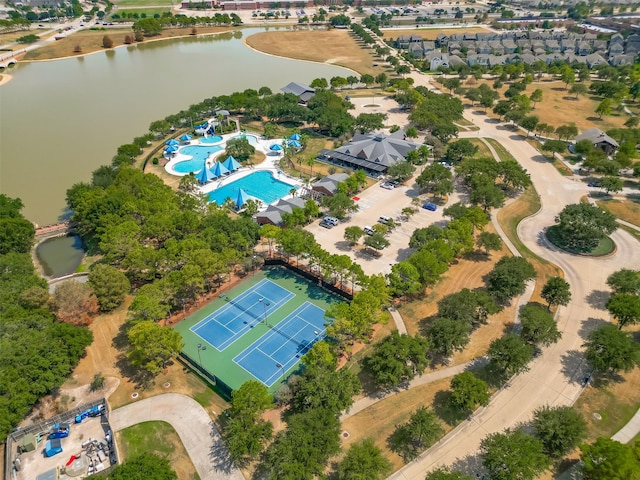 aerial view of property and surrounding area with a large body of water and a pool