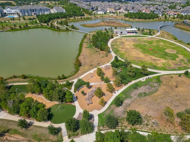 aerial view of property and surrounding area with a large body of water and nearby suburban area