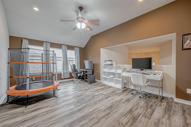office space featuring wood finished floors, a ceiling fan, baseboards, lofted ceiling, and recessed lighting