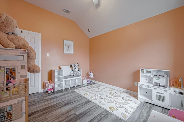 rec room featuring wood finished floors, vaulted ceiling, and baseboards