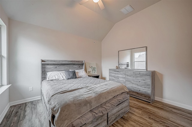 bedroom with wood finished floors, baseboards, vaulted ceiling, and ceiling fan