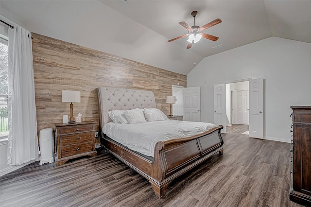 bedroom with multiple windows, wooden walls, lofted ceiling, wood finished floors, and a ceiling fan