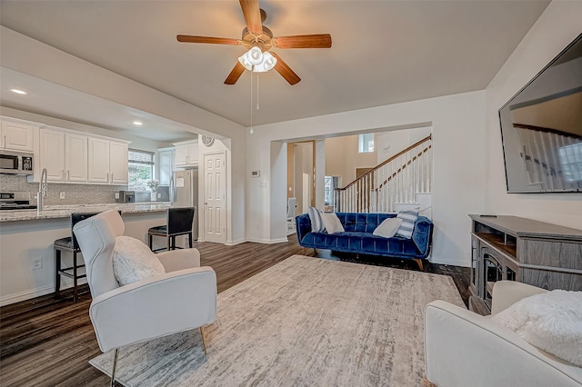 living room with dark wood finished floors, stairway, ceiling fan, baseboards, and recessed lighting