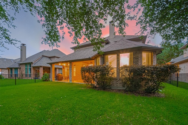 back of property with a chimney and brick siding