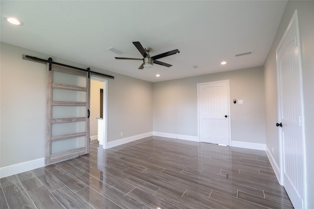 214 Canadian St, Houston, TX 77009 - unfurnished room featuring a barn door, recessed lighting, wood finished floors, baseboards, and ceiling fan