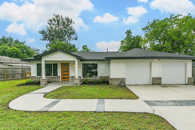 single story home featuring a garage and a front lawn