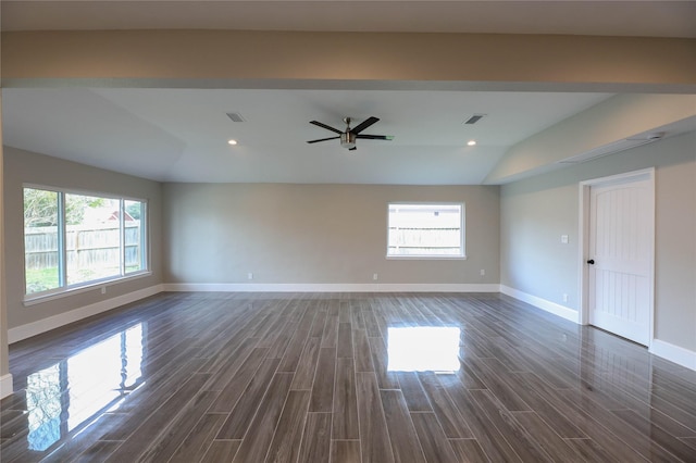 empty room with ceiling fan, dark hardwood / wood-style flooring, and vaulted ceiling