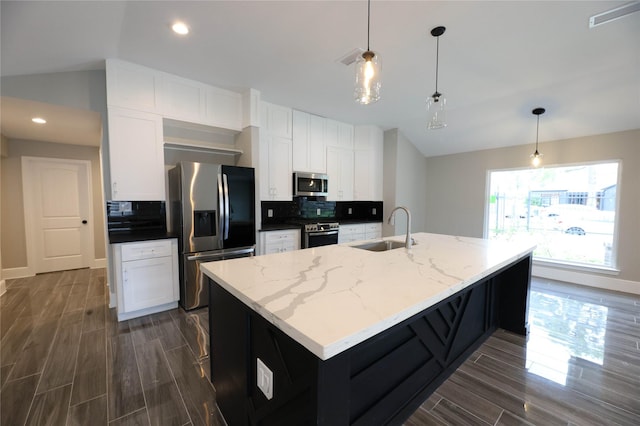 kitchen with sink, decorative light fixtures, stainless steel appliances, light stone countertops, and white cabinets