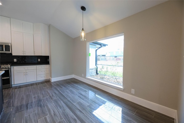 kitchen with dark wood-type flooring, white cabinetry, tasteful backsplash, appliances with stainless steel finishes, and pendant lighting