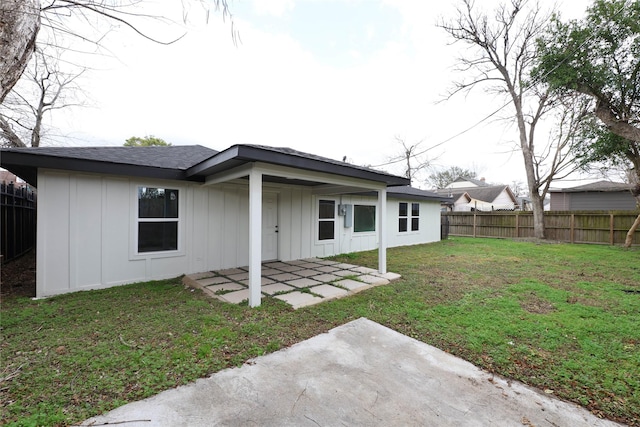 214 Canadian St, Houston, TX 77009 - rear view of house with board and batten siding, a yard, a fenced backyard, and a patio