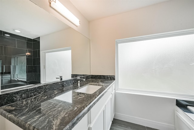 214 Canadian St, Houston, TX 77009 - full bath featuring vanity, baseboards, recessed lighting, a tile shower, and wood finished floors